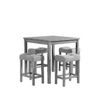Gray dining table with four matching stools in a room with large windows and decorative elements.