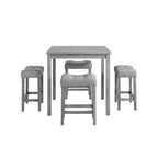 Gray dining set with table and chairs in a room with decor elements.