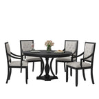 Dining room with a black round table and chairs in a modern interior setting.